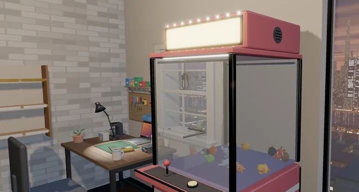 An apartment workshop at dusk with a claw machine, a small desk and the city lights outside the window.